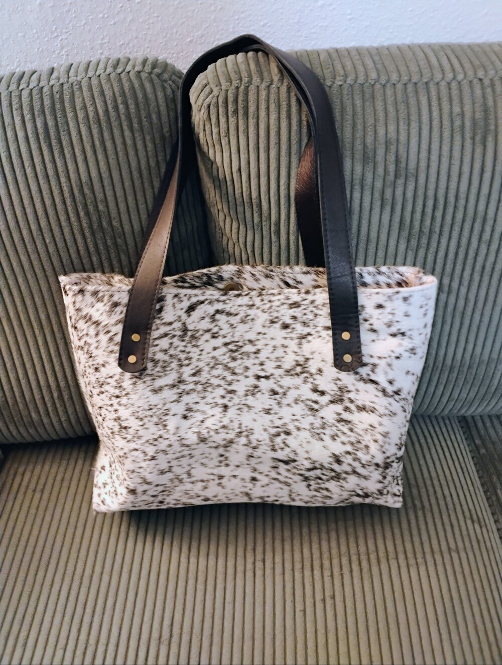 Spotted Cowhide Tote Bag with Black and Whitespots. Leather Straps Back.